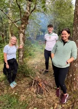 trinzo team posing for picture in woods
